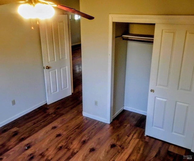 unfurnished bedroom featuring dark hardwood / wood-style floors and a closet