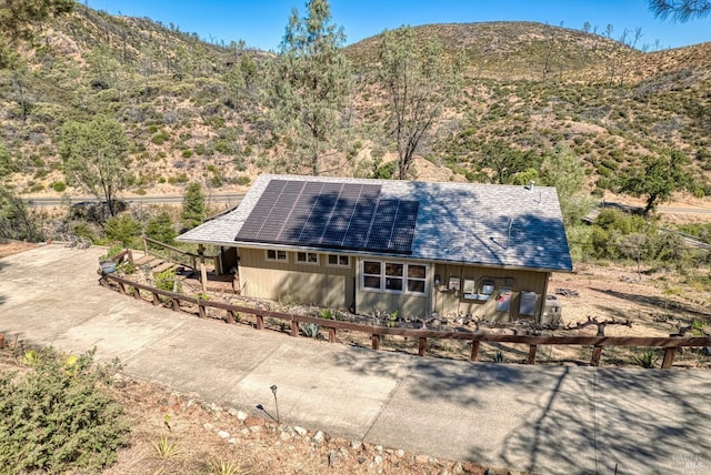 exterior space featuring a mountain view and solar panels