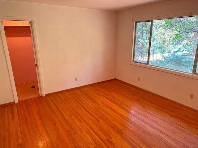 unfurnished room with light wood-type flooring