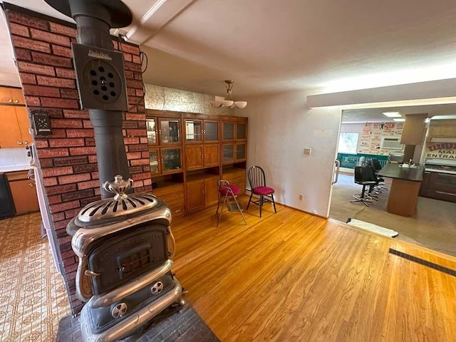 living room with light hardwood / wood-style flooring and a wood stove