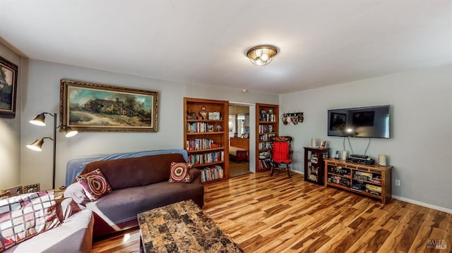living room with wood finished floors and baseboards