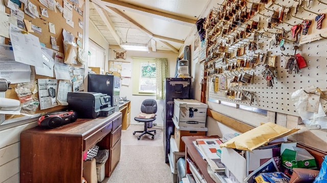 home office with light carpet and vaulted ceiling with beams