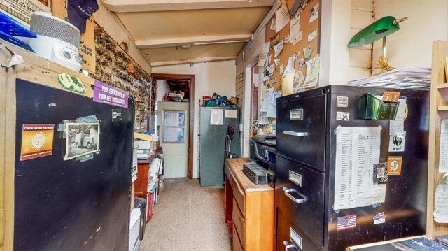 kitchen with carpet floors and beam ceiling