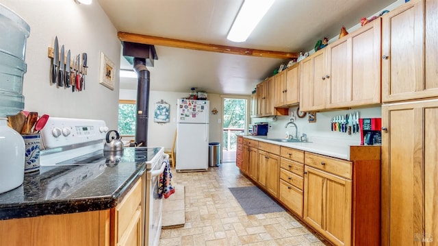 kitchen featuring white appliances, light tile patterned floors, sink, dark stone counters, and beam ceiling