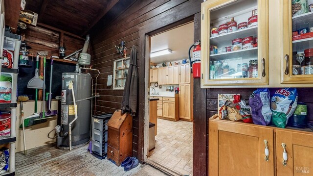 storage room featuring gas water heater and sink