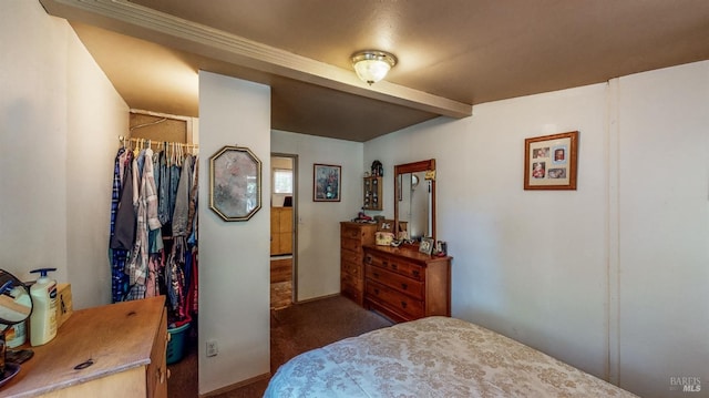bedroom featuring beam ceiling and carpet flooring