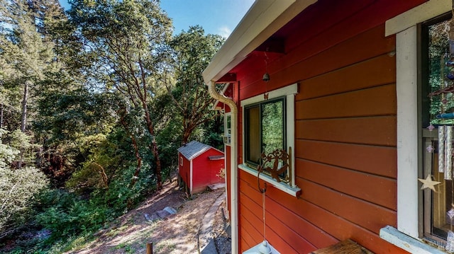 view of side of property with a shed