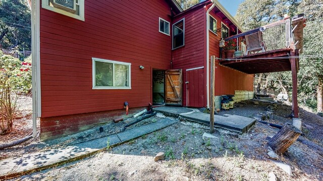back of property featuring a wooden deck