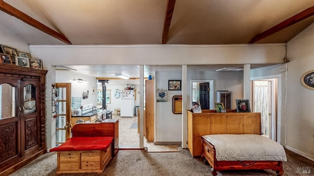 carpeted living room with vaulted ceiling with beams