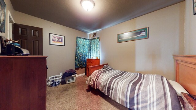 bedroom featuring baseboards and carpet flooring