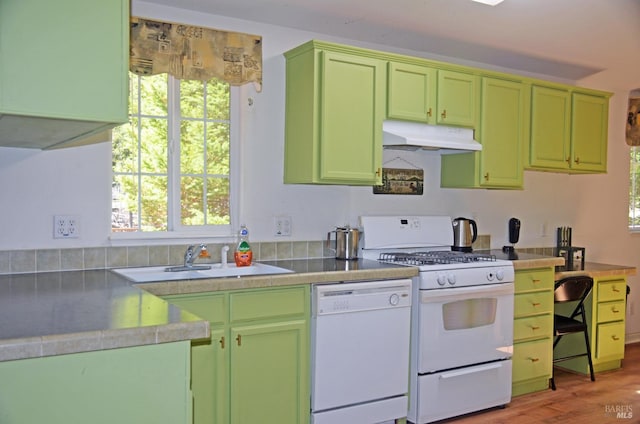 kitchen featuring sink, hardwood / wood-style flooring, white appliances, and green cabinets