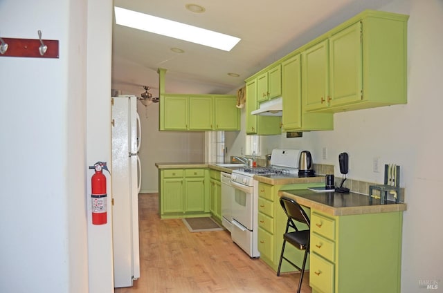 kitchen featuring green cabinets, white appliances, and light hardwood / wood-style flooring