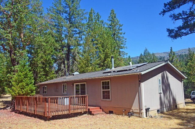 rear view of house featuring a deck