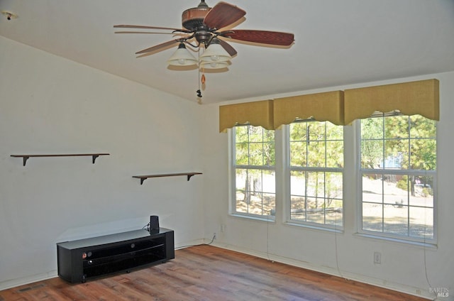 living room with wood-type flooring and ceiling fan