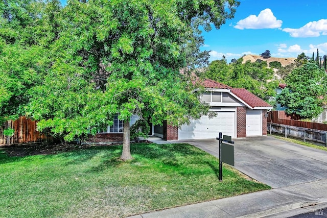 view of front of property featuring a garage and a front yard