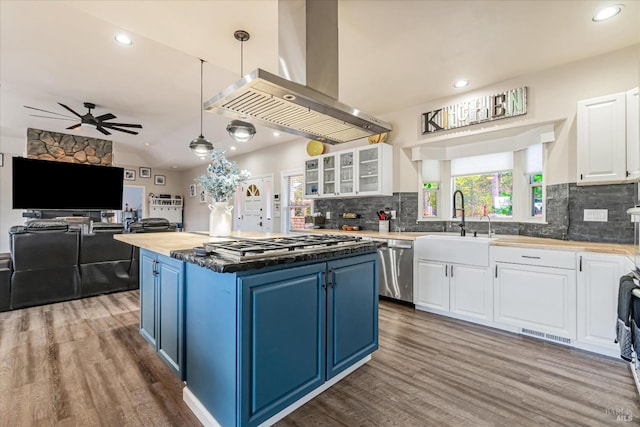 kitchen with blue cabinetry, white cabinets, stainless steel appliances, and ceiling fan