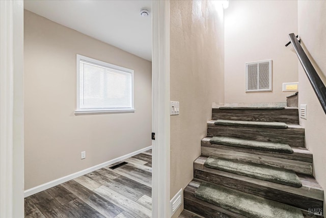 staircase featuring wood-type flooring