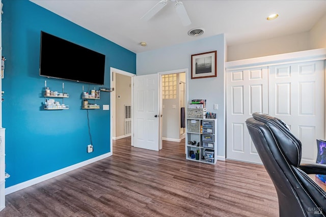 unfurnished office with dark hardwood / wood-style flooring and ceiling fan