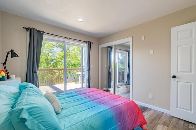 bedroom featuring light hardwood / wood-style floors and access to outside