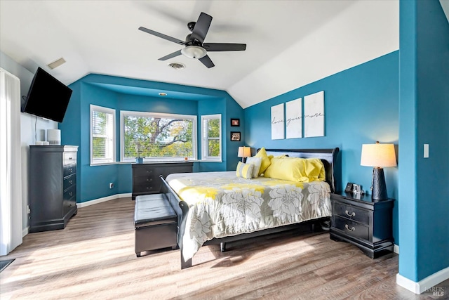 bedroom featuring wood-type flooring, lofted ceiling, and ceiling fan