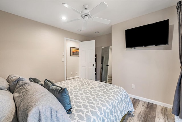 bedroom with wood-type flooring and ceiling fan