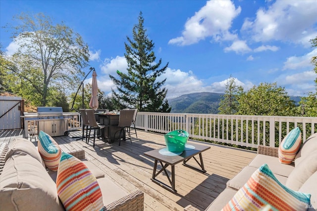 wooden terrace featuring outdoor lounge area and a mountain view