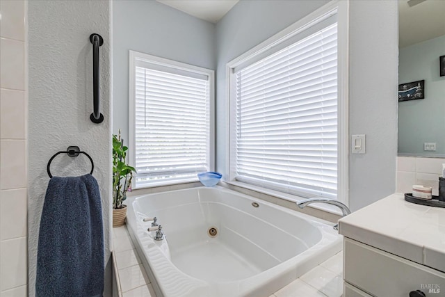 bathroom with tiled tub and vanity