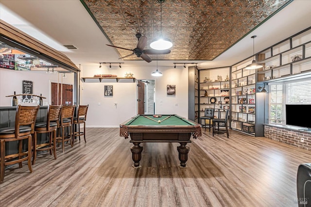 game room featuring rail lighting, billiards, brick wall, wood-type flooring, and ceiling fan