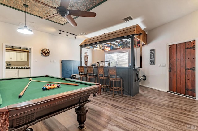 playroom featuring wood-type flooring, billiards, ceiling fan, and bar area