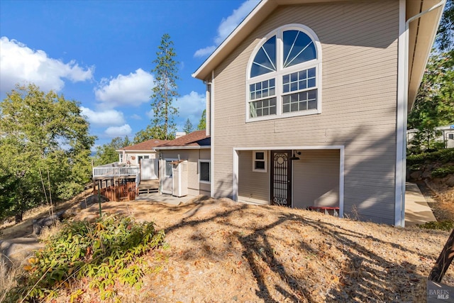 back of property featuring a wooden deck