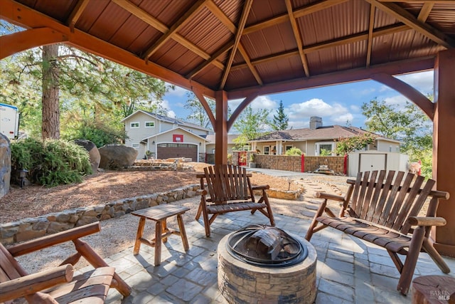 view of patio featuring a shed, a gazebo, and an outdoor fire pit