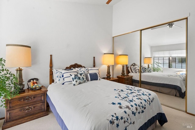 bedroom featuring light colored carpet and a closet