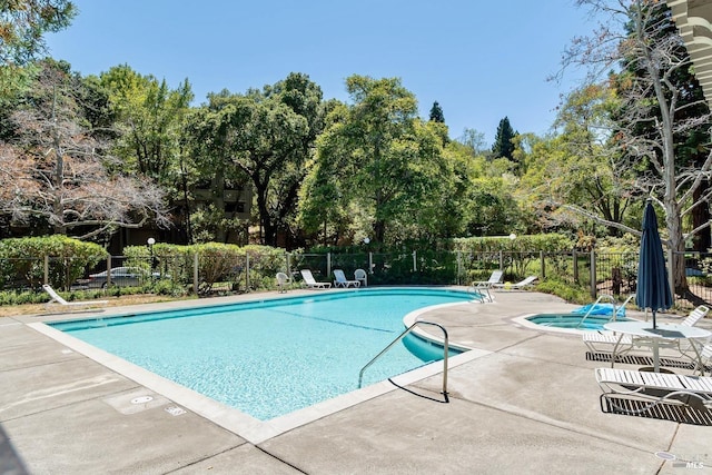 view of pool featuring a patio area and a hot tub