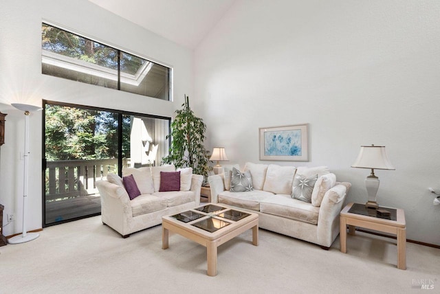 carpeted living room with high vaulted ceiling