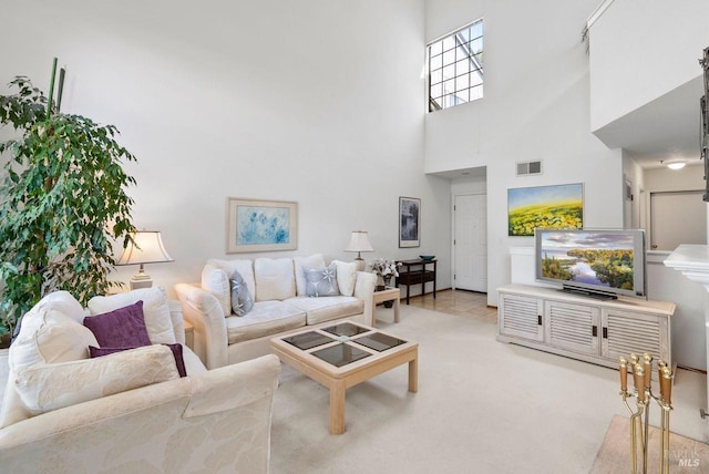 carpeted living room with a towering ceiling