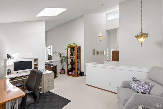 carpeted office with plenty of natural light, a skylight, and a high ceiling