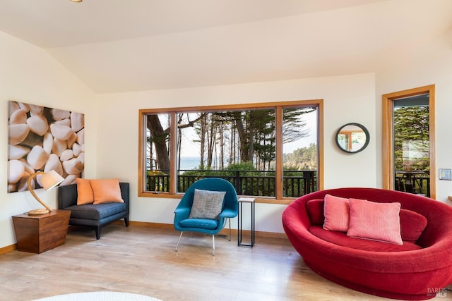 living area with lofted ceiling and light wood-type flooring