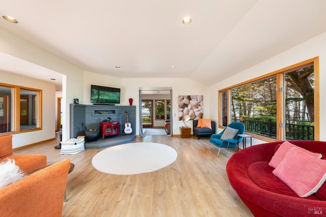 living room featuring vaulted ceiling and light hardwood / wood-style flooring