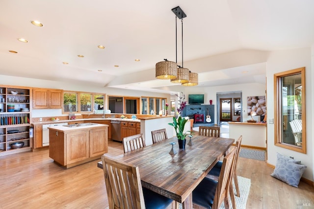 dining area featuring lofted ceiling and light hardwood / wood-style floors