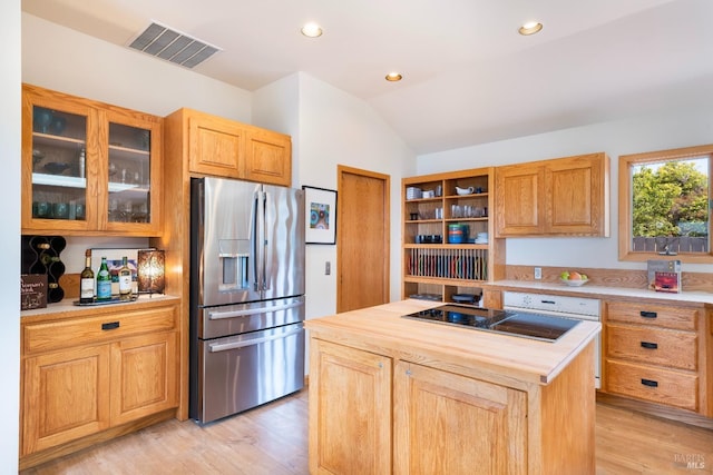 kitchen with lofted ceiling, stainless steel fridge, a center island, light hardwood / wood-style floors, and wood counters