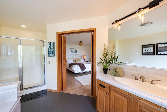 bathroom with vanity, wood-type flooring, backsplash, and walk in shower