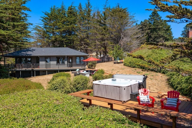 view of yard with a hot tub and a wooden deck