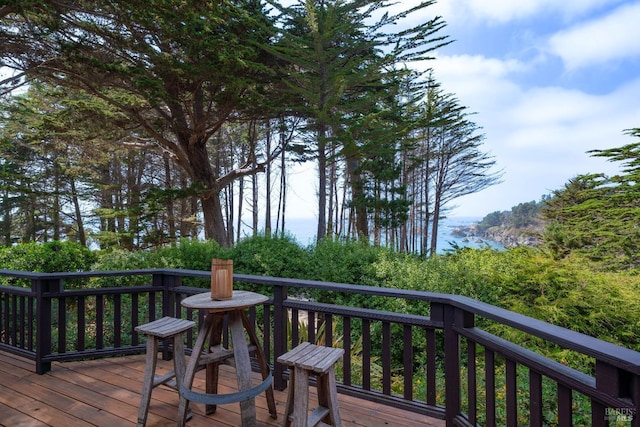 wooden deck featuring a water view