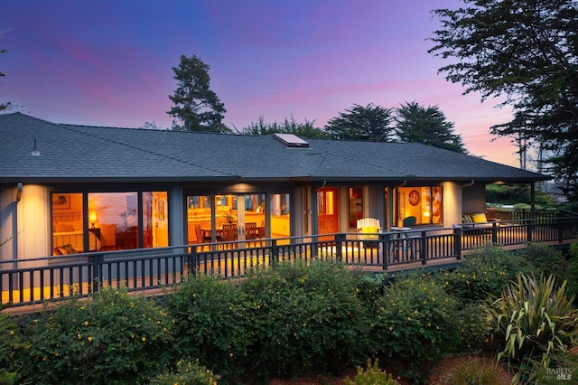 view of back house at dusk