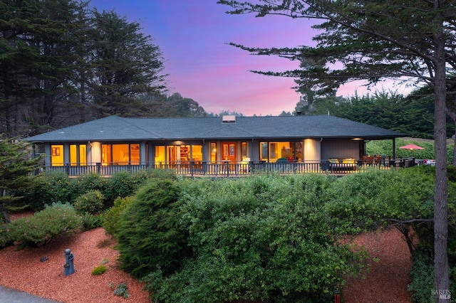 view of back house at dusk