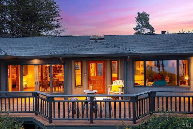 view of back house at dusk