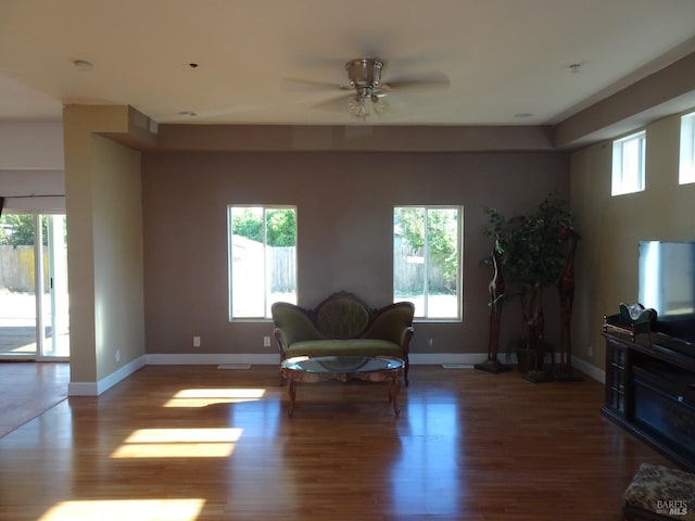 living room with hardwood / wood-style floors, ceiling fan, and a wealth of natural light