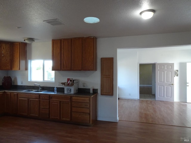 unfurnished room with dark hardwood / wood-style flooring and a textured ceiling