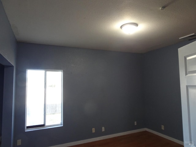 spare room featuring hardwood / wood-style floors