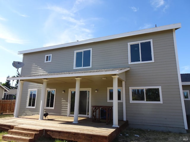 back of house with central AC unit and a deck